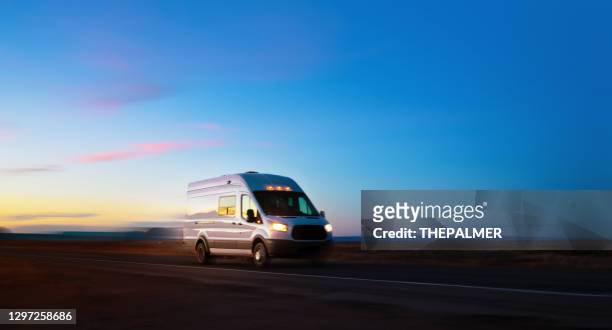 white delivery van driving on rural road in monument valley arizona usa - dark country road stock pictures, royalty-free photos & images