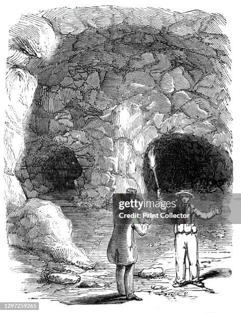 Jack Cade's cavern, Blackheath, 1844. Men using a flaming torch to explore the caves below the caves under Blackheath, south-east London. From...