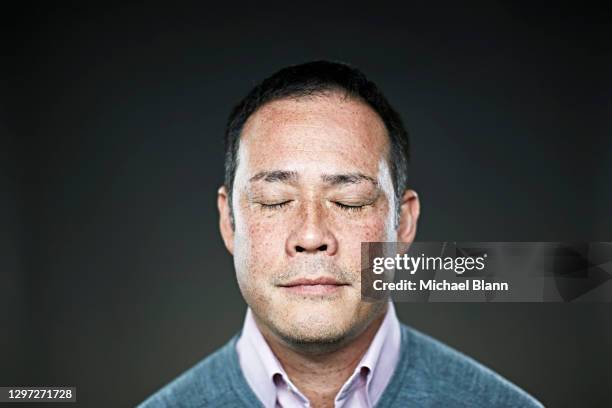 portrait of man with eyes closed thinking - michael virtue stock pictures, royalty-free photos & images