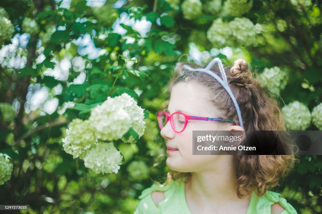 Girl Smelling Flowers
