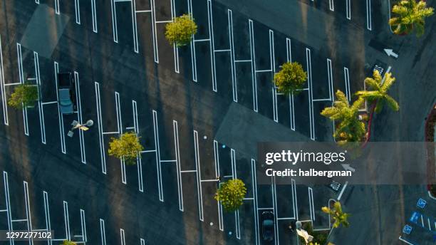 top down drone shot of angled spaces in near empty parking lot - echo park los angeles stock pictures, royalty-free photos & images