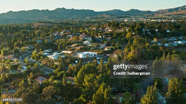 evening sunlight on single family homes in northridge with view of wider san fernando valley - northridge california stock pictures, royalty-free photos & images