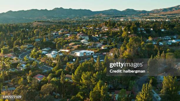 evening sunlight on single family homes in northridge with view of wider san fernando valley - northridge stock pictures, royalty-free photos & images