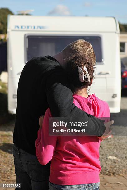 Couple of residents embrace during the eviction of Dale Farm travellers' camp on October 20, 2011 in Basildon, England. Bailiffs and police are...