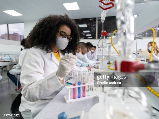 student wearing a facemask in a science class at the lab - classroom masks stock pictures, royalty-free photos & images