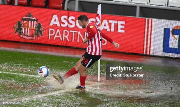 Sunderland player Aiden McGeady takes a corner for Sunderland in the rain saturated corner of the pitch during the Sky Bet League One match between...