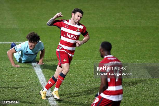 Jon Taylor of Doncaster Rovers celebrates after scoring their side's first goal during the Sky Bet League One match between Doncaster Rovers and...