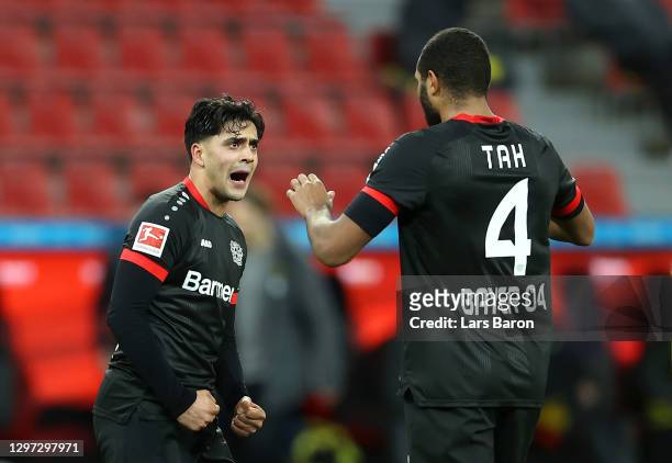 Paulinho and Jonathan Tah of Bayer 04 Leverkusen celebrate following their side's victory in the Bundesliga match between Bayer 04 Leverkusen and...