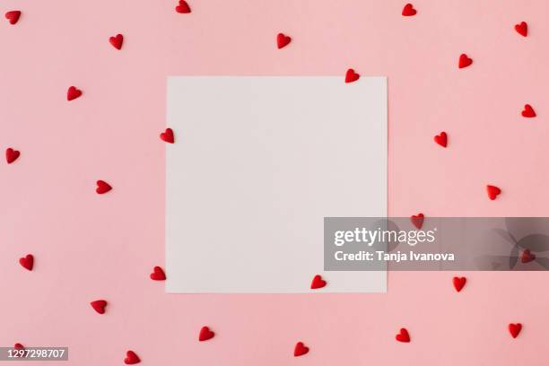 valentine's day background february 14th. blank greeting card mock-up scene, red hearts confetti on pink background. valentines day creative concept. flat lay, top view, copy space. - valentines background fotografías e imágenes de stock