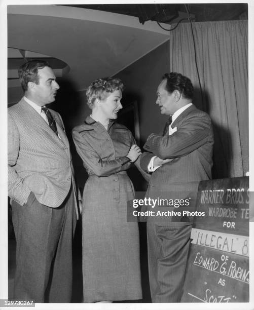 Director Lewis, Allen Nina Foch, and Edward G Robinson having conversation on the set of the film 'Illegal', 1955.