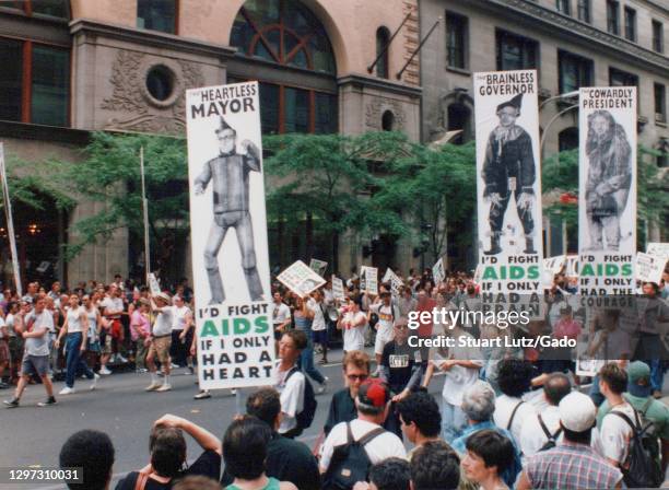 An AIDS awareness group walks on Fifth Avenue, carrying signs depicting politicians, including Mayor Rudy Giuliani, Governor George Pataki, and...