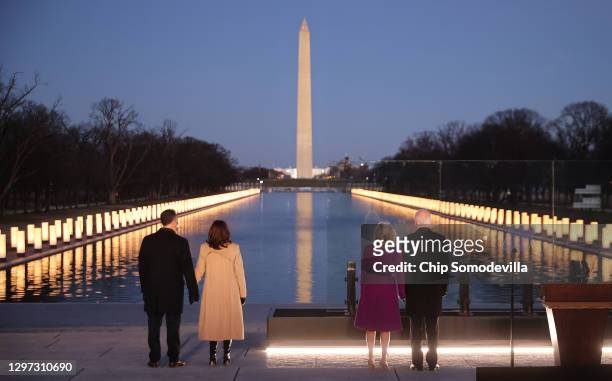 Douglas Emhoff, U.S. Vice President-elect Kamala Harris, Dr. Jill Biden and U.S. President-elect Joe Biden look down the National Mall as lamps are...
