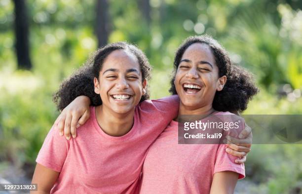 identical twin sisters, african-american teenagers - pink colour stock pictures, royalty-free photos & images