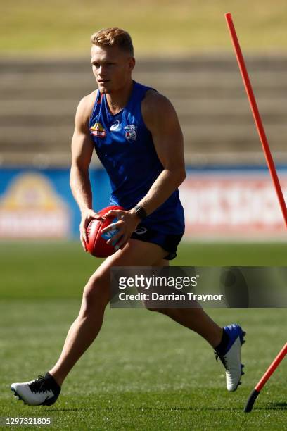 Adam Treloar of the Bulldogs is runs with the ball during a Western Bulldogs AFL training session at Whitten Oval on January 20, 2021 in Melbourne,...