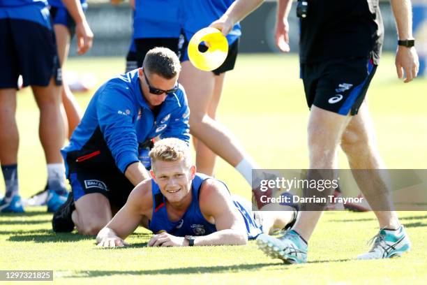 Adam Treloar of the Bulldogs has his legs massaged during a Western Bulldogs AFL training session at Whitten Oval on January 20, 2021 in Melbourne,...