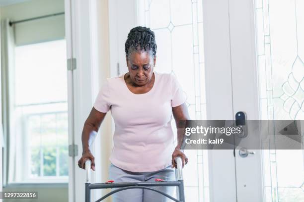 senior african-american woman using walker - mobility walker stock pictures, royalty-free photos & images