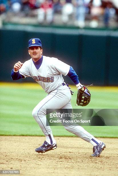 Edgar Martinez of the Seattle Mariners fields ground ball during batting practice before an Major League Baseball game against the Oakland Athletics...