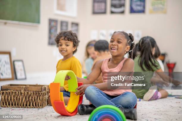 i'm building the biggest funniest tower! - montessori education stock pictures, royalty-free photos & images