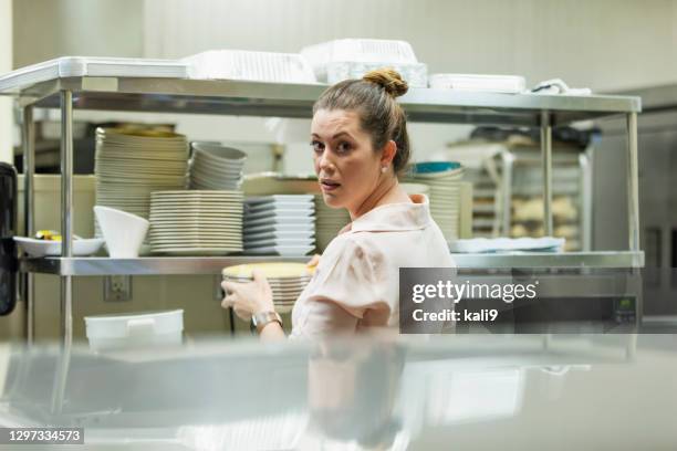 hispanic woman working in restaurant - overworked waitress stock pictures, royalty-free photos & images