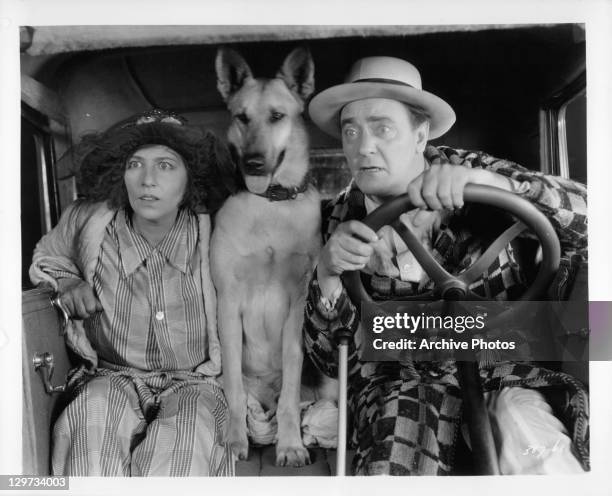 Polly Moran Flash The Dog Harry Gribbon sitting in a car in a scene from the film 'Honeymoon', 1928.