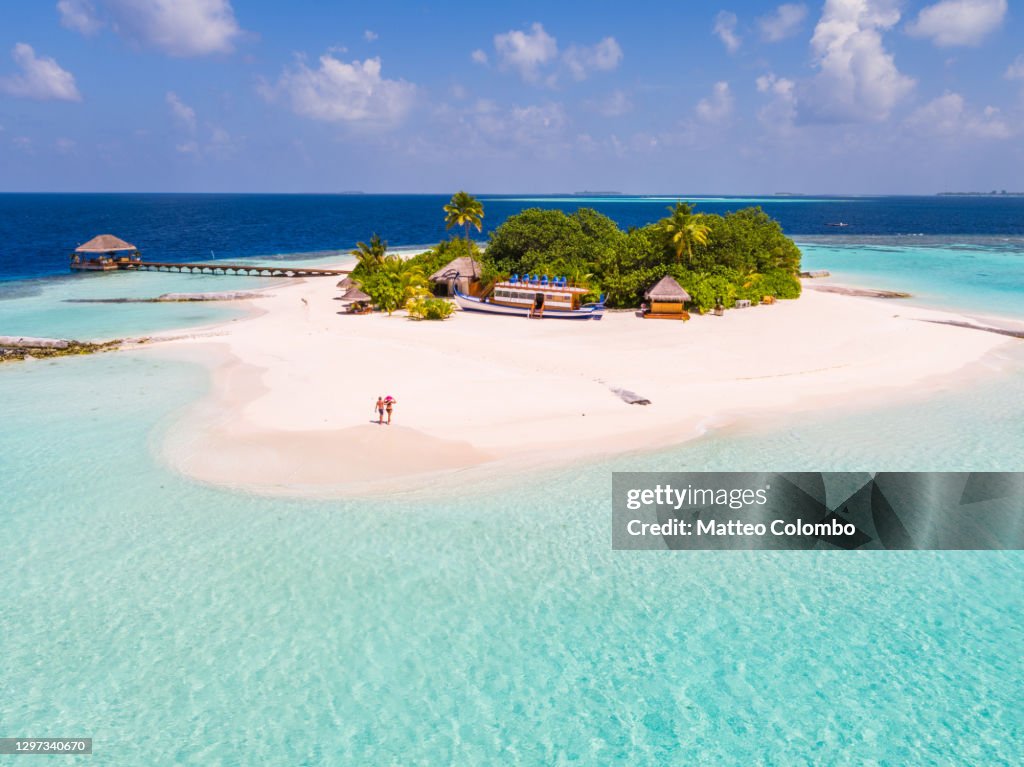 Drone view of adult couple on a beach, Maldives