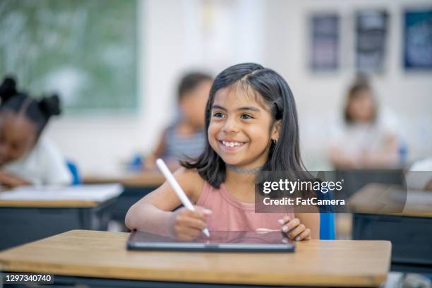 learning using my tablet - spanish and portuguese ethnicity stock pictures, royalty-free photos & images