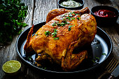 Roast chicken on wooden table