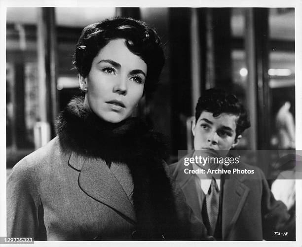 Jennifer Jones looking ahead with Dick Beymer in the background in a scene from the film 'Indiscretion Of An American Wife', 1953.