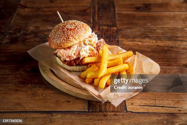 chicken burger in brioche bun garnished with coleslaw salad, served with fries - crunchy salad stock pictures, royalty-free photos & images