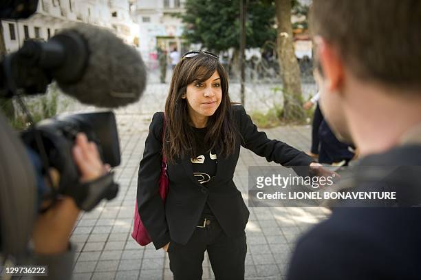 Famous Tunisian blogger Lina Ben Mhenni adresses journalists on Bourguiba avenue in tunis on October 20 days before a historic national election in...
