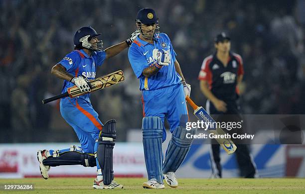 India captain MS Dhoni celebrates with Ravindra Jadeja after winning the 3rd One Day International between India and England at The Punjab Cricket...