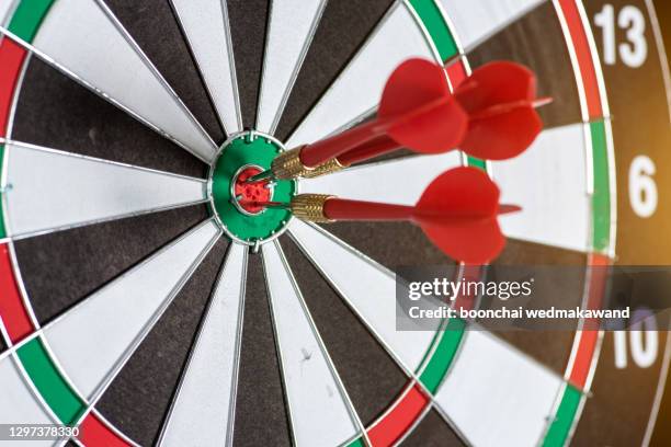 red three darts in the target centre business goal concept. - prefect stock-fotos und bilder