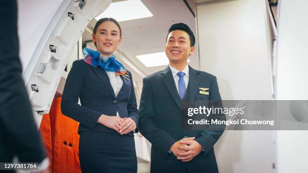 air stewardess welcome in front of airplane - first class plane stockfoto's en -beelden