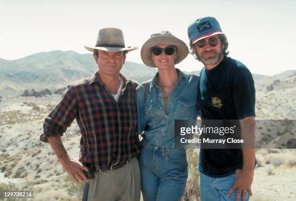 From left to right, actors Sam Neill and Laura Dern pose with American director Steven Spielberg in a publicity still for the film 'Jurassic Park',...