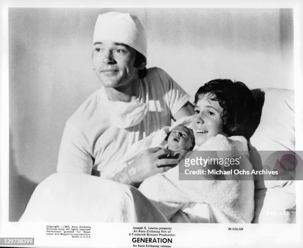 Pete Duel is at Kim Darby showing their newborn baby in a scene from the film 'Generation', 1969.