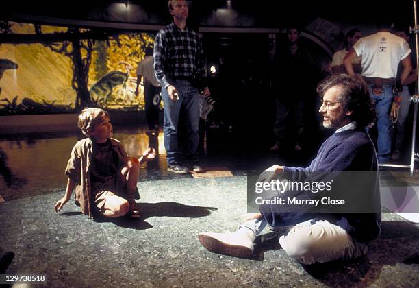 American director Steven Spielberg with child actor Joseph Mazzello during the filming of 'Jurassic Park', 1993.