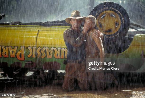 Actor Sam Neill as Dr. Alan Grant and Ariana Richards as Lex try to avoid the attentions of a Tyrannosaurus Rex in a scene from the film 'Jurassic...