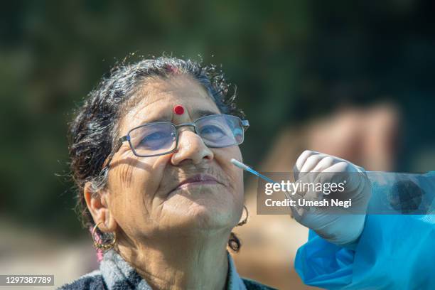medic taking sample for coronavirus testing in india - coronavirus india stock pictures, royalty-free photos & images