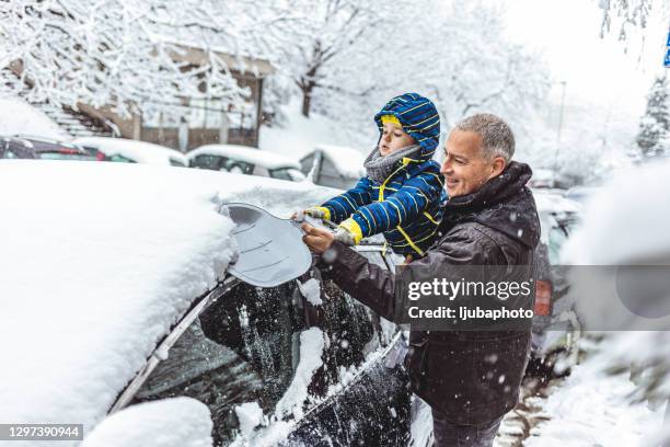 they're having so much fun - shoveling snow stock pictures, royalty-free photos & images