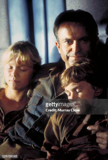 Actor Sam Neill as Dr. Alan Grant, with Ariana Richards and Joseph Mazzello as Lex and Tim, in a scene from the film 'Jurassic Park', 1993.