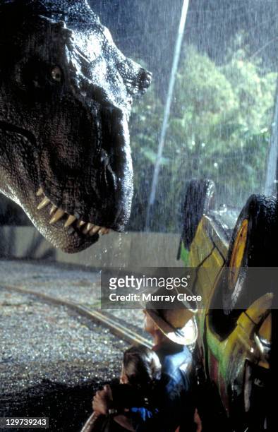 Actor Sam Neill as Dr. Alan Grant and Ariana Richards as Lex try to avoid the attentions of a Tyrannosaurus Rex in a scene from the film 'Jurassic...