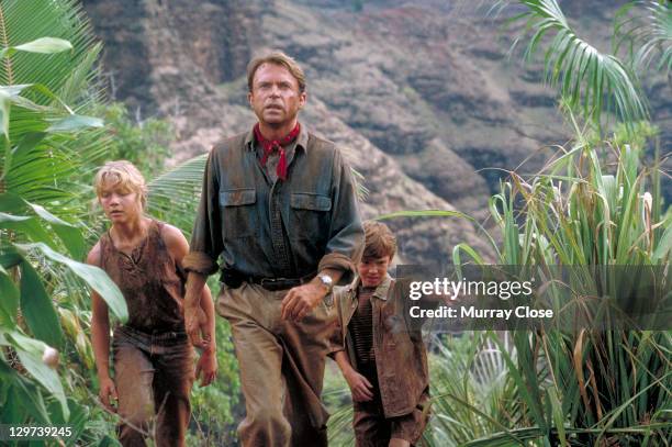 Actor Sam Neill as Dr. Alan Grant, with Ariana Richards and Joseph Mazzello as Lex and Tim, in a scene from the film 'Jurassic Park', 1993.