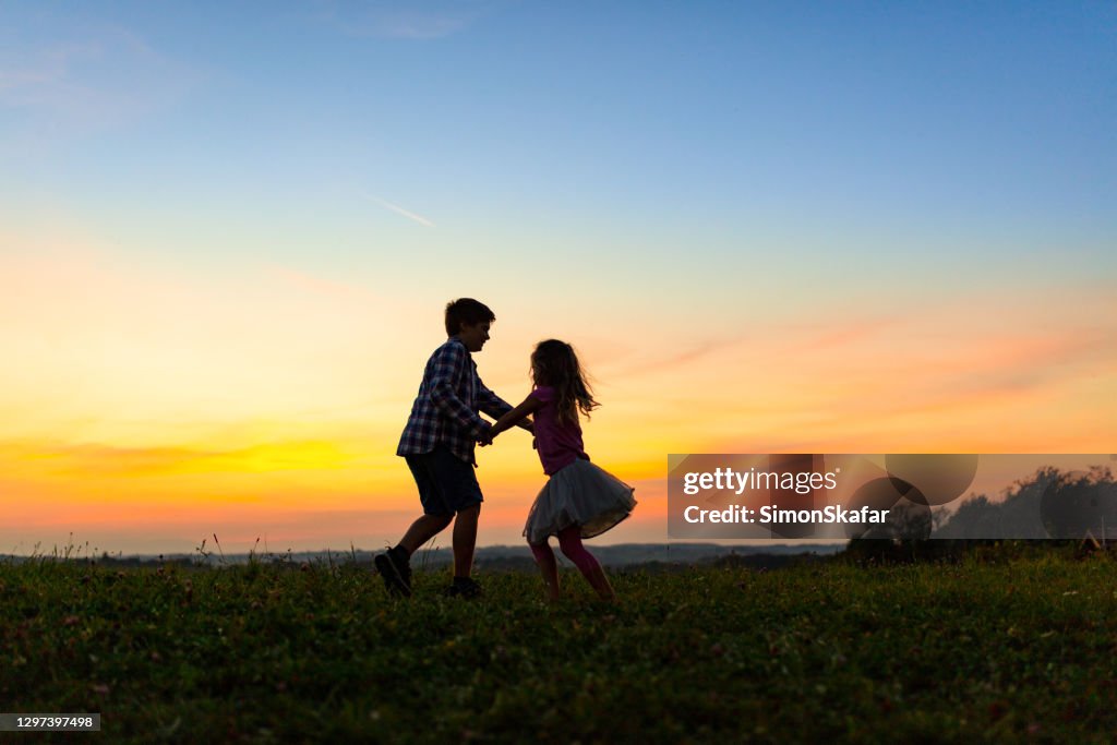 Isbling Fun Siblings Fun On Grass Field High-Res Stock Photo - Getty Images