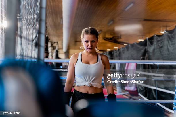 female boxer standing on boxing ring - boxing womens stock pictures, royalty-free photos & images