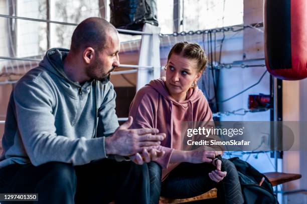 female boxer discussing with coach - boxing coach stock pictures, royalty-free photos & images