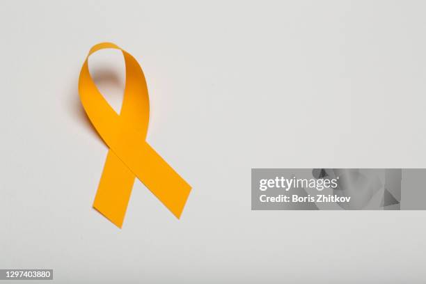 orange awareness ribbon. - cancer ribbon stock-fotos und bilder