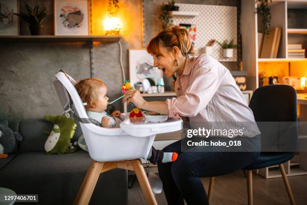 mother feeding her little baby boy - baby eating toy stock pictures, royalty-free photos & images