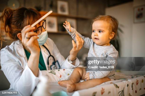 throat examination at pediatrician - turner syndrome photos stock pictures, royalty-free photos & images