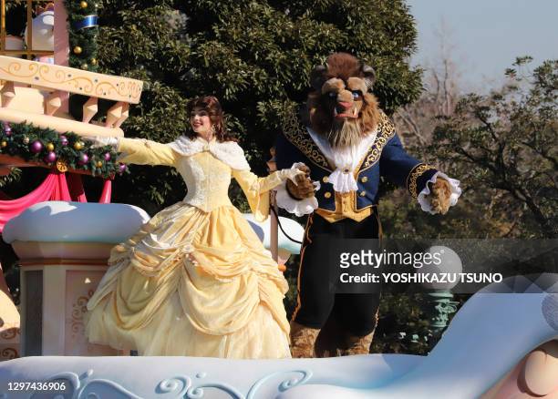 Disney movie "Beauty and the Beast" characters Belle and Beast perform on the float during a parade for Christmas at the Tokyo Disneyland at Urayasu,...