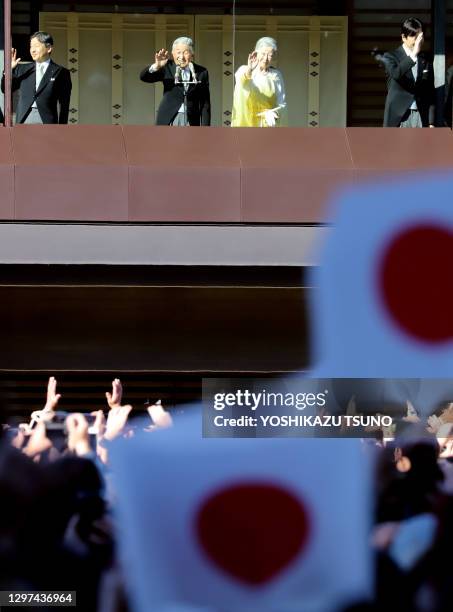 Japanese Emperor Akihito , accompanied by Empress Michiko , Crown Prince Naruhito and Prince Akishino waves to wellwishers gathered for New Year's...